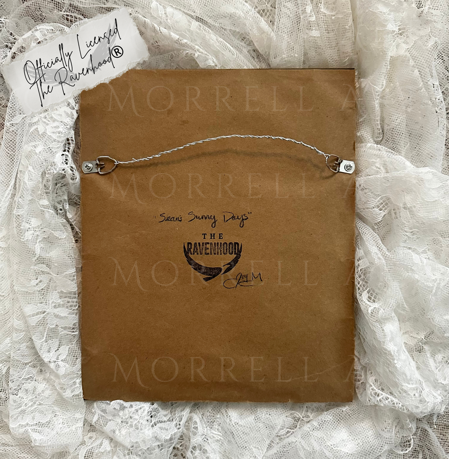 Brown paper bag with 'Morrell' branding on a lace background